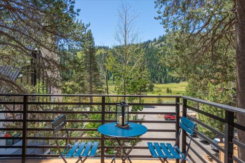 a table and chairs on a balcony with a view at Alpenglow Loft condo in Olympic Valley