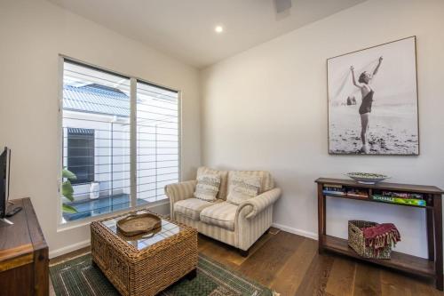 a living room with a couch and a television at Reflections Emerald Villa 1 in Picnic Bay