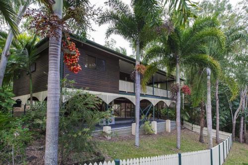 a building with palm trees in front of it at Marramaninjie in Arcadia