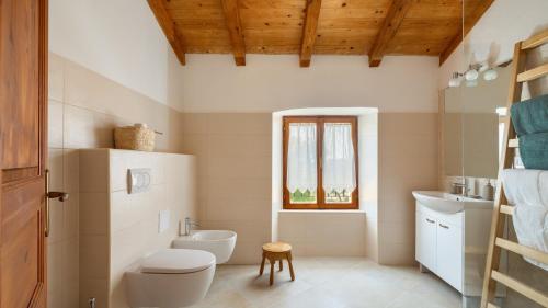 a bathroom with a toilet and a sink at Old House Grota by Villas Guide in Umag
