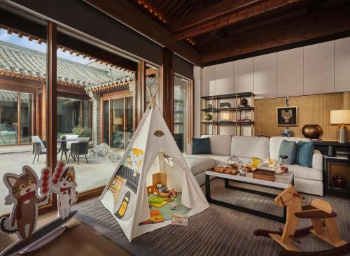 a living room with a couch and a play tent at Mandarin Oriental Qianmen, Beijing in Beijing