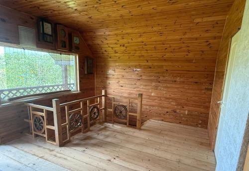 an inside view of a wooden room with a window at Krustceles in Baltinava