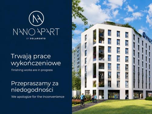 a sign in front of a white building at NanoApart by Solarento in Warsaw