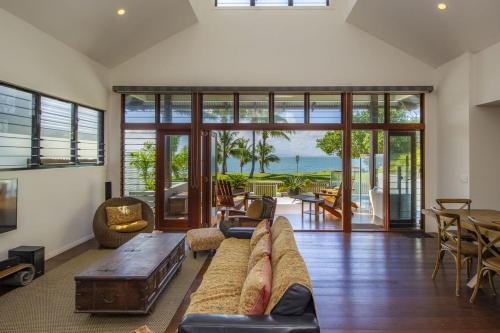 a living room with a couch and a table at Beached on Magnetic in Picnic Bay