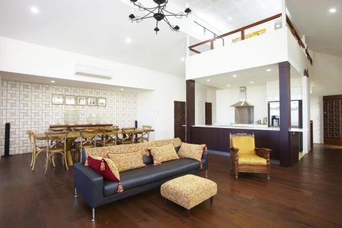 a living room with a couch and a table at Beached on Magnetic in Picnic Bay