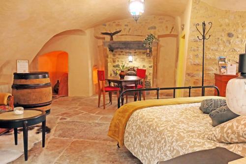a bedroom with a bed and a table in a room at Chambre d'Hôtes La Chadeleufade in Chadeleuf