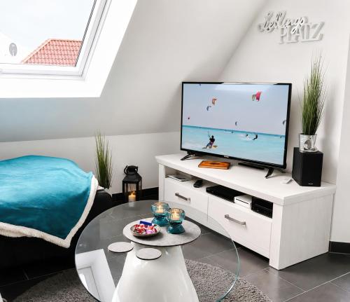 a living room with a tv and a coffee table at Sonnendeck 36 - Großenbrode in Grossenbrode