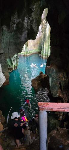 a group of people swimming in a river in a cave at Vatudei Homestay - Yasawa Islands in Somosomo