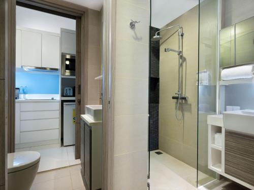 a bathroom with a shower and a toilet at Cassia Bintan, part of Banyan Group in Lagoi
