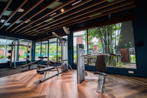 a gym with treadmills and ellipticals in a room at Trival Property Homestay Sri Indah Sandakan in Sandakan