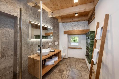 a bathroom with a sink and a shower at Seehaus 96 Hallstatt in Hallstatt