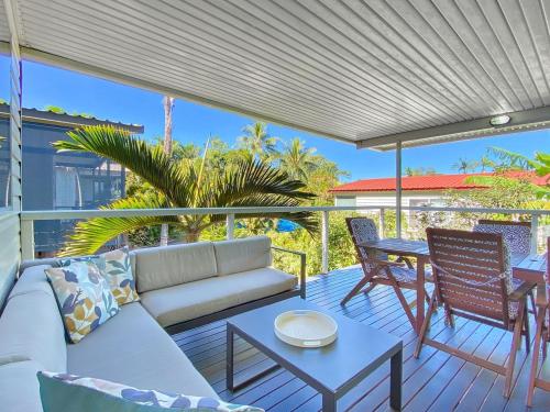 a porch with a couch and a table and chairs at Magnetic Haven Unit 5 in Arcadia