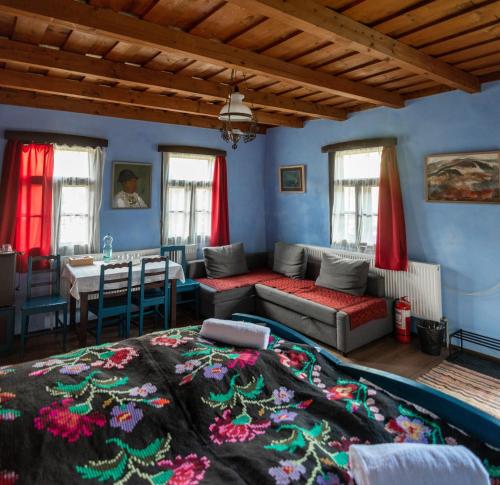 a living room with a bed and a table at Gyimesi Skanzen in Valea Boroş