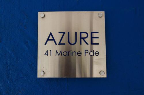a sign on a blue wall that says zire minute pole at Azure on Geoffrey Bay in Arcadia