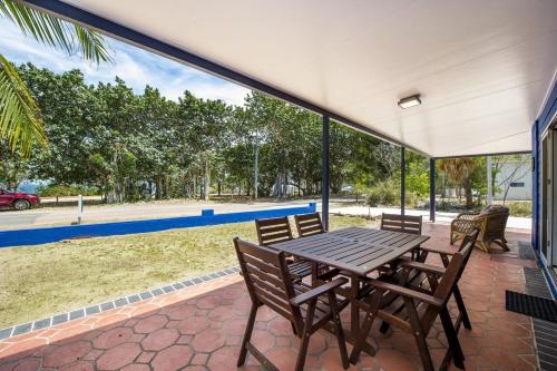 a table and chairs on a patio with a view at Azure on Geoffrey Bay in Arcadia