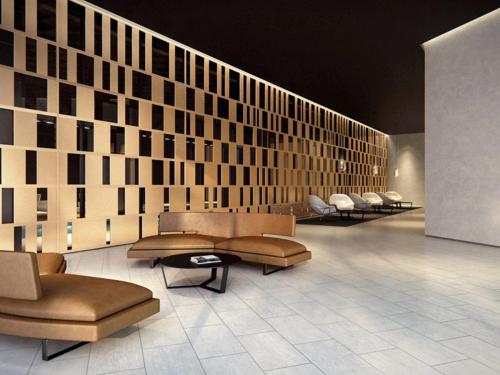 a lobby with couches and chairs in a room at Stylish 2-Bed Apartment by 888 Collins in Melbourne