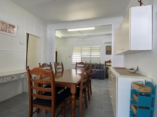 a kitchen and dining room with a table and chairs at Whitehaven 2 in Picnic Bay