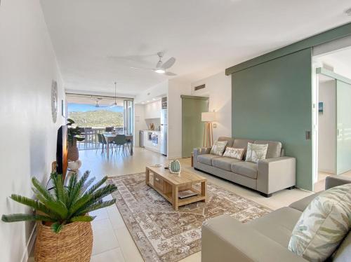 a living room with a couch and a table at 1 Bright Point Apartment 1407 in Nelly Bay