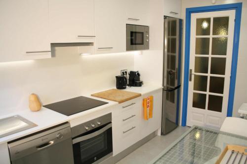 a kitchen with white counters and a stove top oven at Superb Seafront Villa in Cambrils