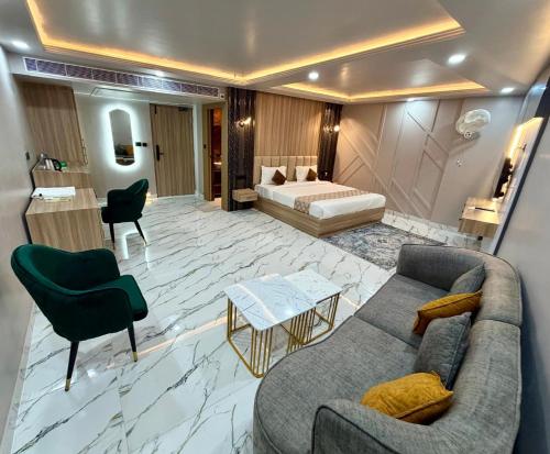a living room with a couch and a bed at Hotel MEDHA Inn in Patna