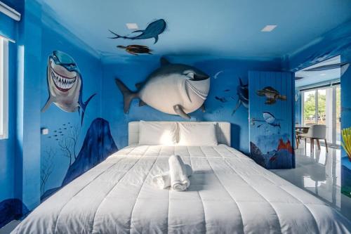 a bedroom with a bed with a shark mural at Shark House - Pool Villa RB13 in Ban Klam
