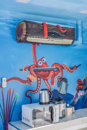 a mural of an octopus on a wall at Shark House - Pool Villa RB13 in Ban Klam