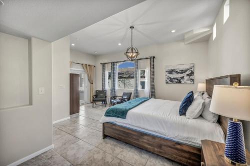 a bedroom with a bed and a desk and a chair at Ultimate Vacation: A Luxurious Oasis with a Pool! in Las Vegas