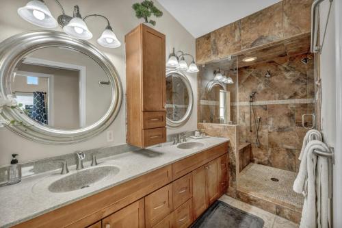 a bathroom with two sinks and a large mirror at Ultimate Vacation: A Luxurious Oasis with a Pool! in Las Vegas