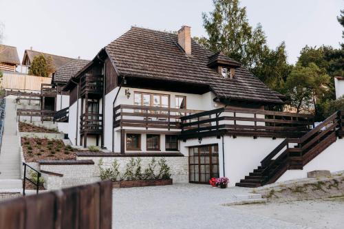 a white house with a brown roof at Luna in Kazimierz Dolny