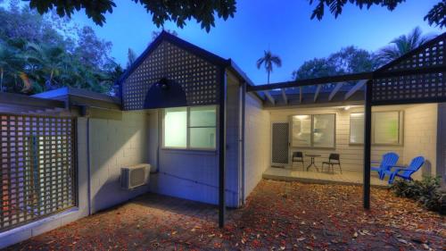 a house with two blue chairs in front of it at Loyang Apartment 2 in Arcadia