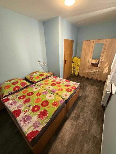a bedroom with a bed with a floral comforter at Apartment Martinec in Nové Město nad Metují