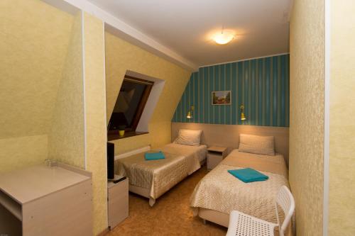 En eller flere senger på et rom på Guest House Orlovskiy