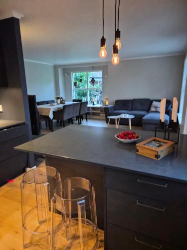 a kitchen and living room with a table and chairs at Garden House 1 in Hvaler
