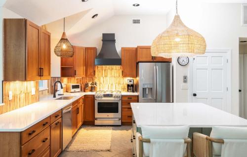 a kitchen with wooden cabinets and a white counter top at Duck Resort with Ocean Views Pool HotTub Elevator in Kitty Hawk Beach
