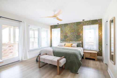 a bedroom with a bed and a wall with windows at Duck Resort with Ocean Views Pool HotTub Elevator in Kitty Hawk Beach