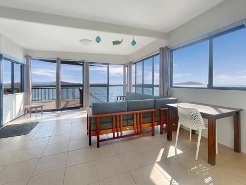 a living room with a couch and a table at Blue on Cockle in Picnic Bay