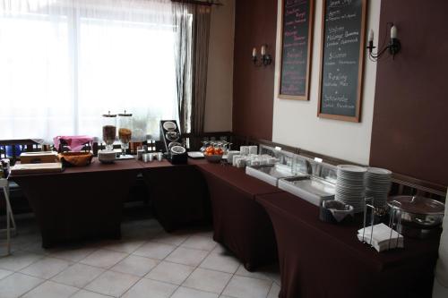 a restaurant with a counter with food on it at Pension Kirchenwirt in Niederaichbach