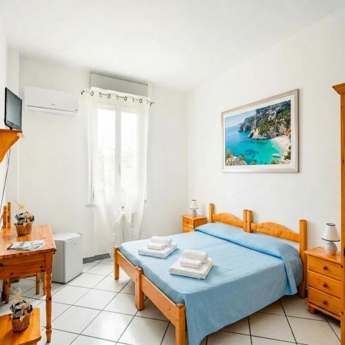 a bedroom with a bed and a view of the ocean at Borgo Moderno in Irgoli