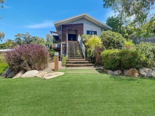 a small house with stairs leading to a yard at Debs Shed in Arcadia