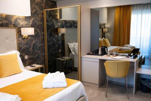 a hotel room with a bed and a desk and a mirror at Divina Charme in Mascalucia
