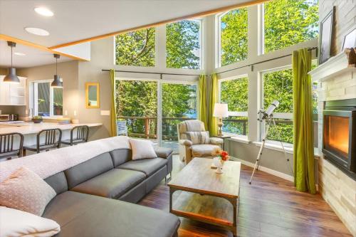 a living room with a couch and a fireplace at A-Frame Cabin Dock Access & Views BBQ in Hoodsport