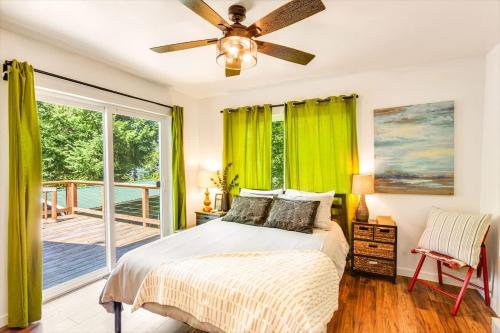a bedroom with a bed with a ceiling fan at A-Frame Cabin Dock Access & Views BBQ in Hoodsport