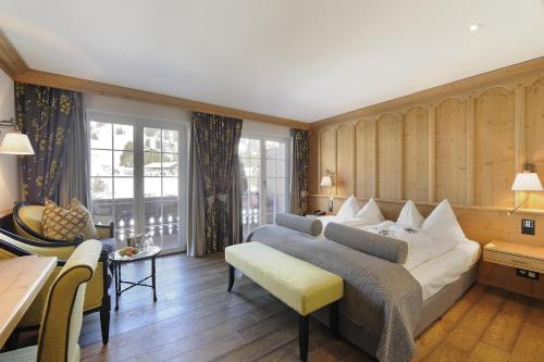 a living room with a couch and a table at ERMITAGE Wellness- & Spa-Hotel in Gstaad