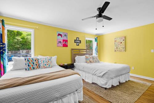 two beds in a room with yellow walls at 2 Bed 1 Bath Private Suite Funky Bunch TYSUT in Louisville