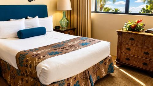 a hotel room with a bed and a dresser at Hawaiian Princess Beachfront 1BR in Waianae