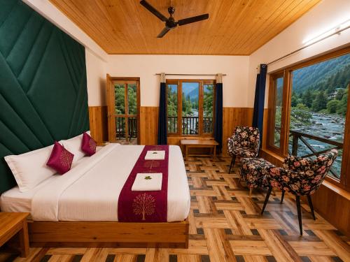 a bedroom with a bed and a table and chairs at Sneha Riverside Cottage, Tirthan Valley - Best selling cottage in Jibhi 2025-26 in Jibhi
