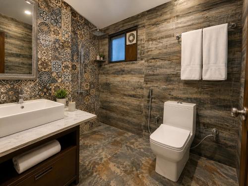 a bathroom with a toilet and a sink at Sneha Riverside Cottage, Tirthan Valley - Best selling cottage in Jibhi 2025-26 in Jibhi