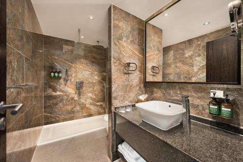 a bathroom with a sink and a shower at Crowne Plaza Gerrards Cross by IHG in Beaconsfield