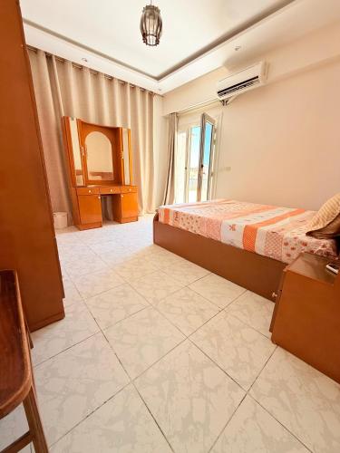 a bedroom with two beds and a window at Luxury Duplex Villa for Rent in Dawwār Muḩammad Abū Shanab