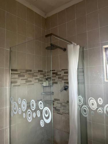 a bathroom with a shower with a shower curtain at Lee Place in Maseru
